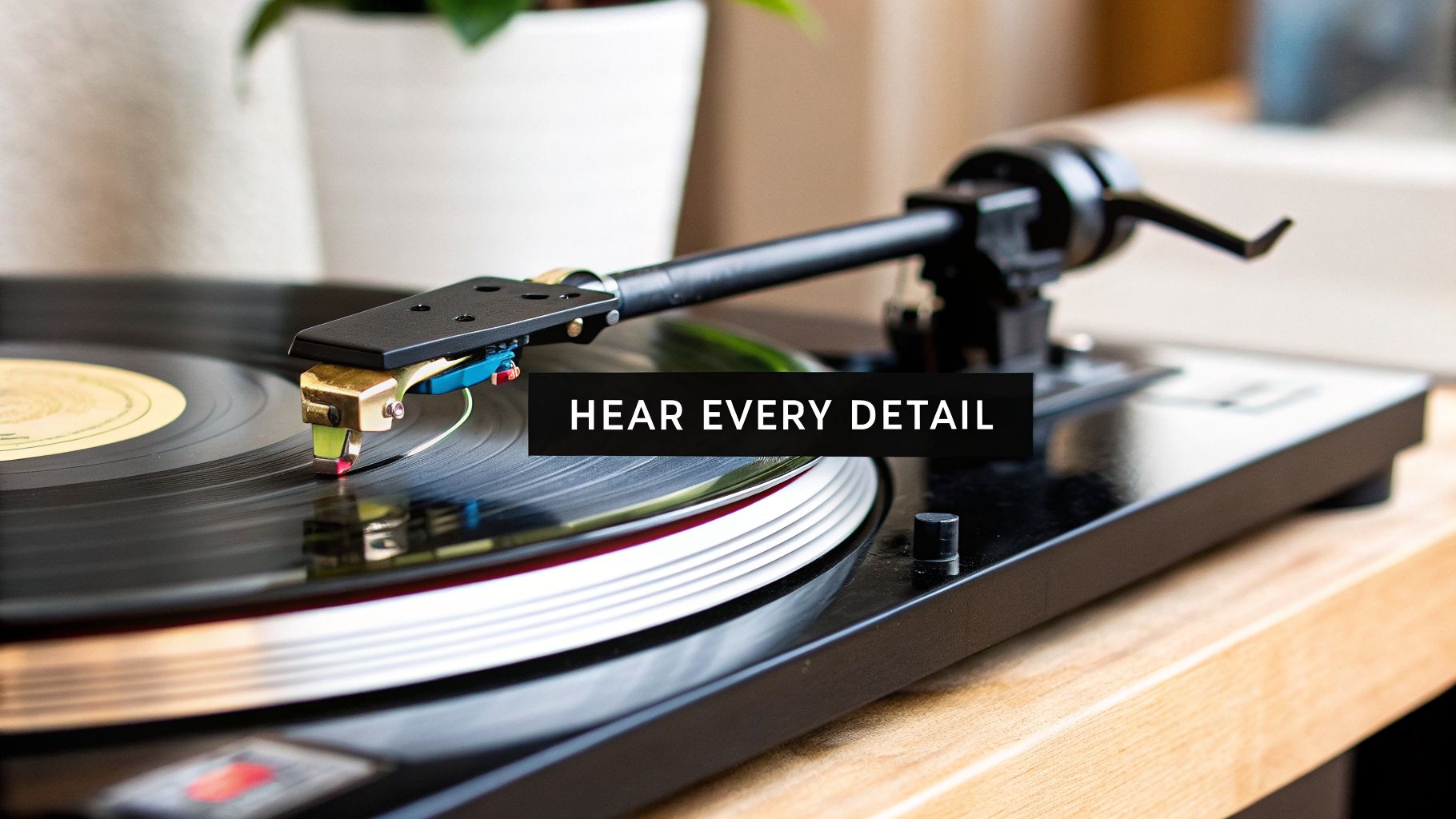 A vintage turntable with a gold stylus playing a black vinyl record, emphasizing high-fidelity sound.