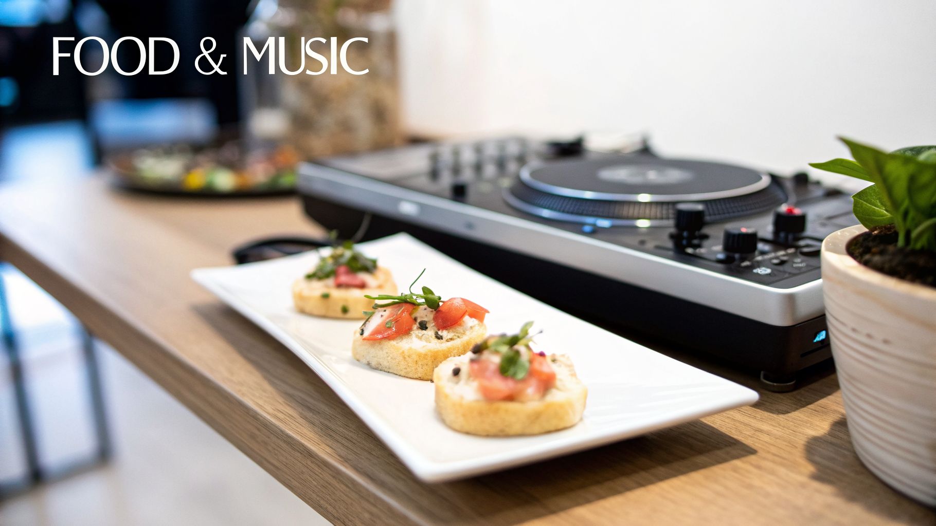 Three small appetizers on a white plate with a DJ mixer and a plant in the background.