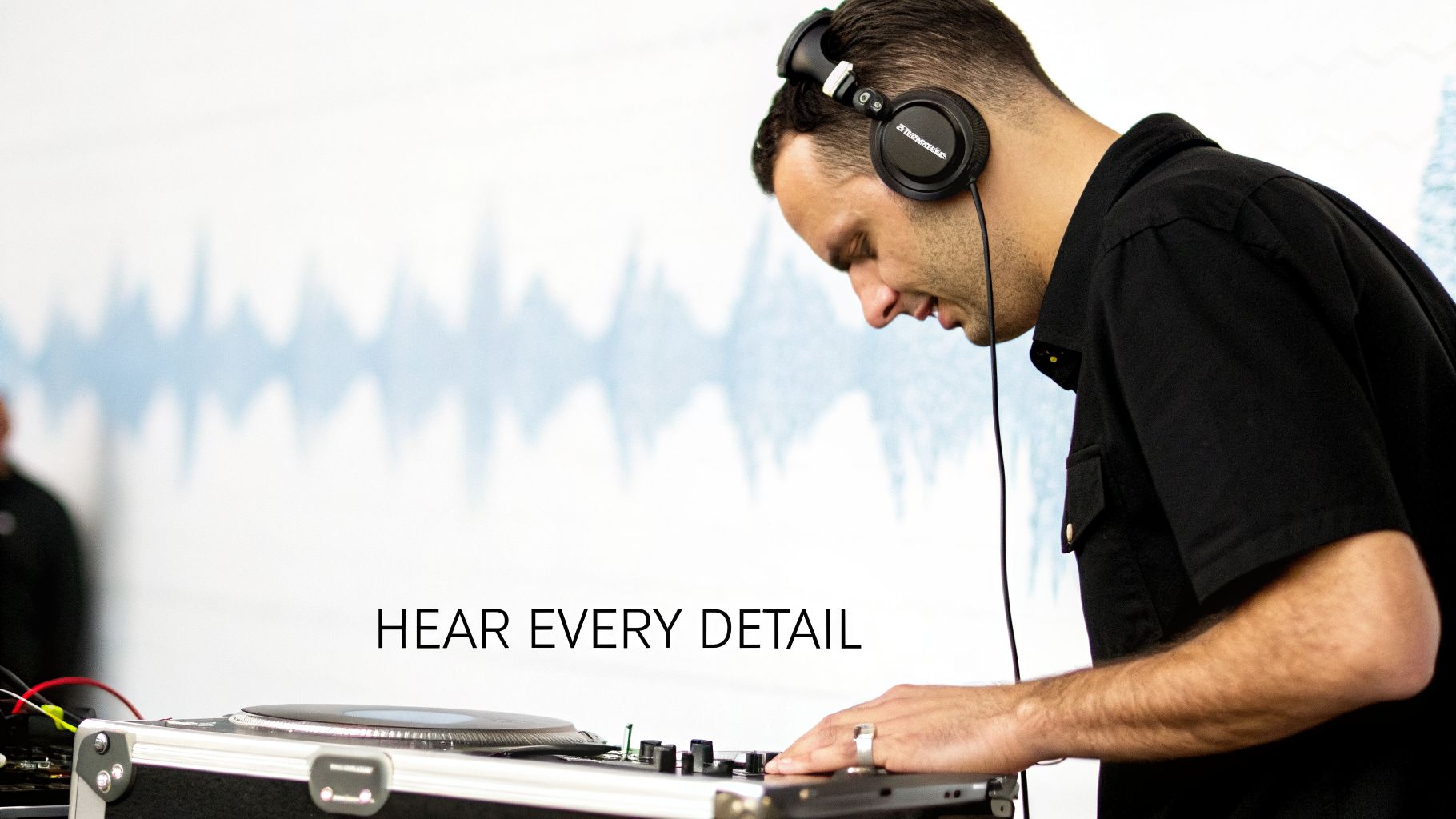 A DJ wearing headphones intently mixing music on a turntable, with a background waveform graphic.