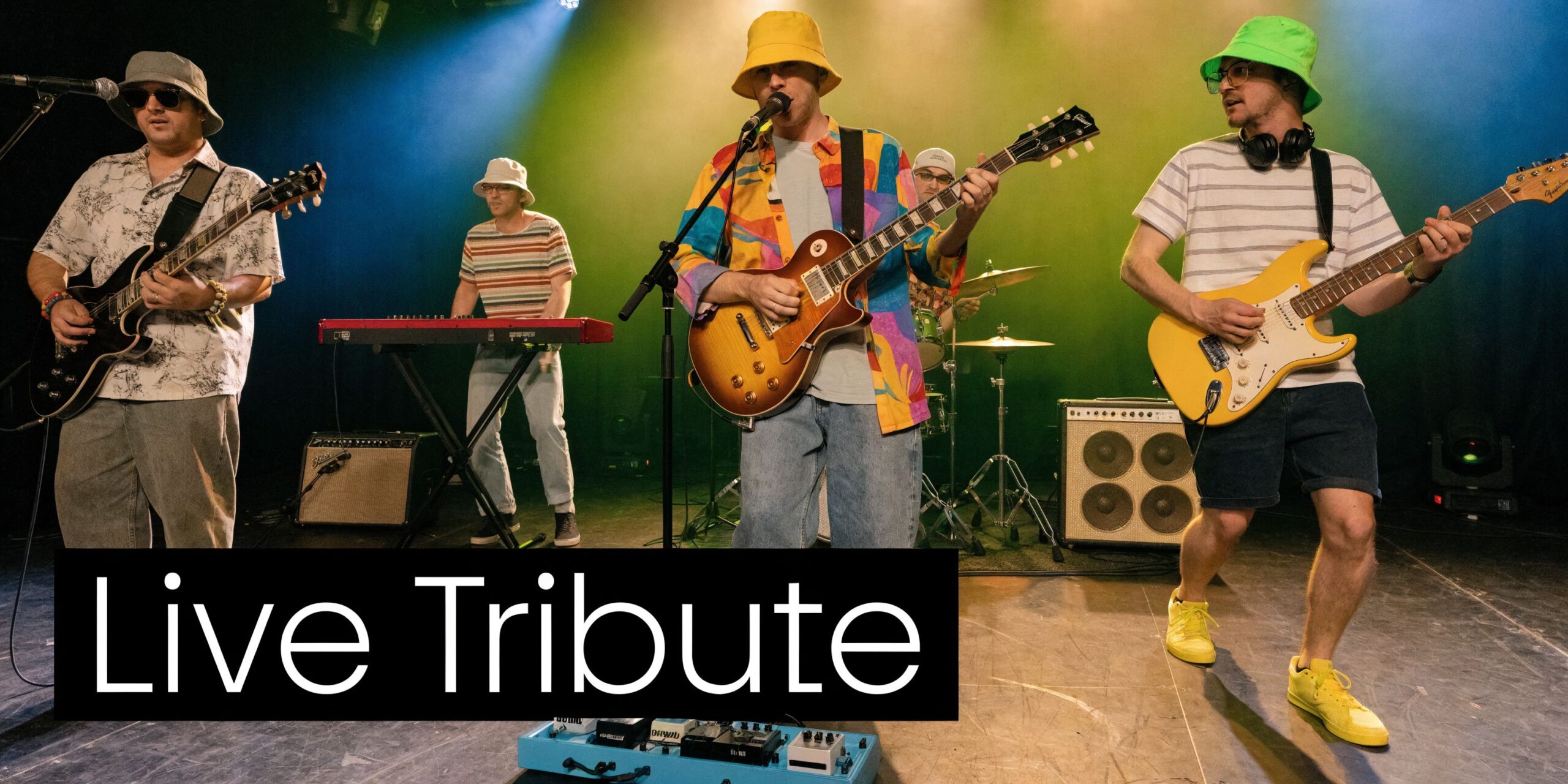 A five-piece indie rock tribute band performing live on stage with guitars, keyboards, and colorful bucket hats.