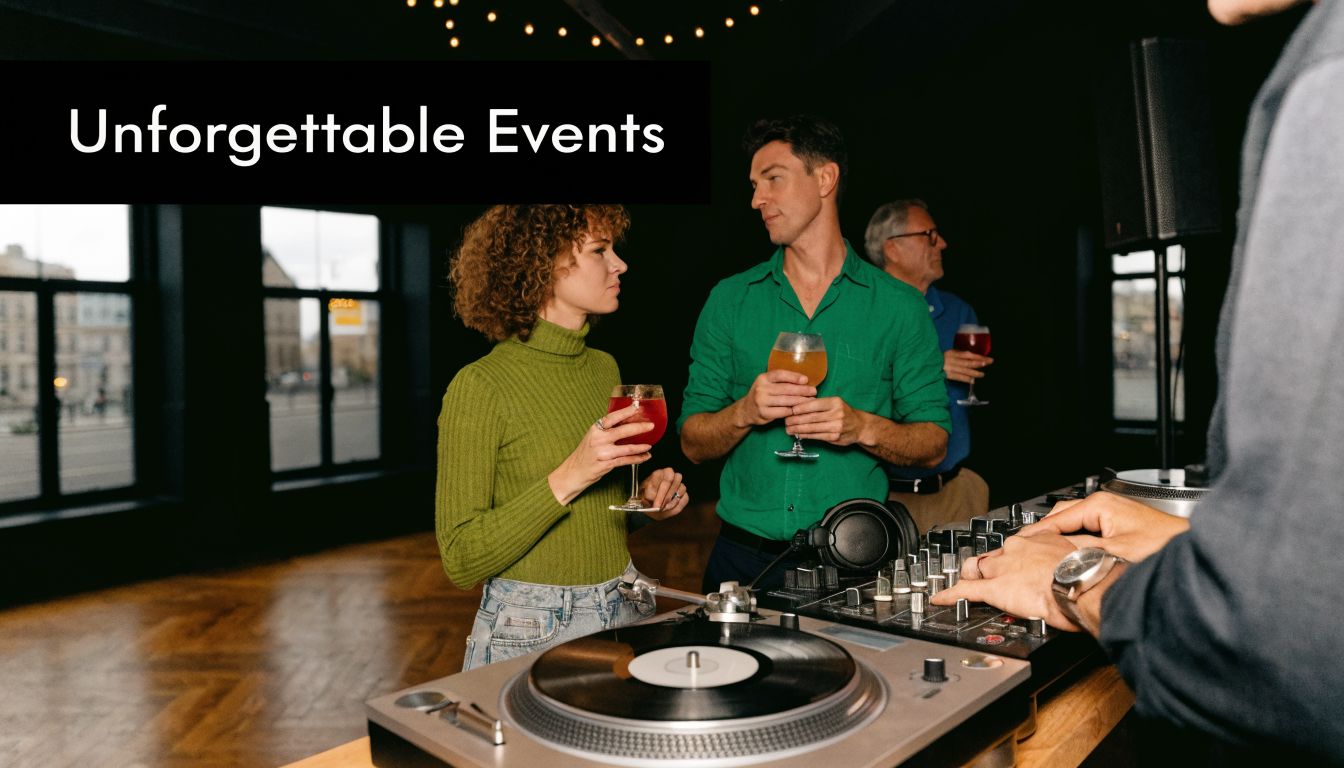 A DJ playing music while a man and woman stand nearby enjoying drinks at an evening event.